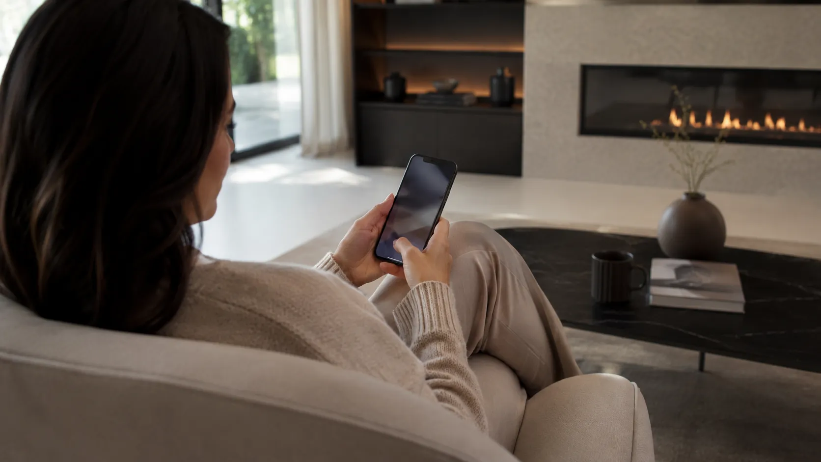 A buyer relaxes in an armchair at home using a phone privately — no calls, no pressure.
